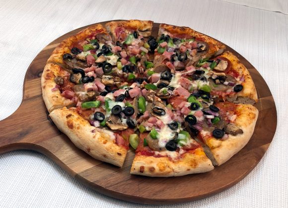 a pizza with a bunch of toppings and other Delivery Pizza in Hollywood, FL, Weston, Miramar, Cooper City, Pembroke Pines